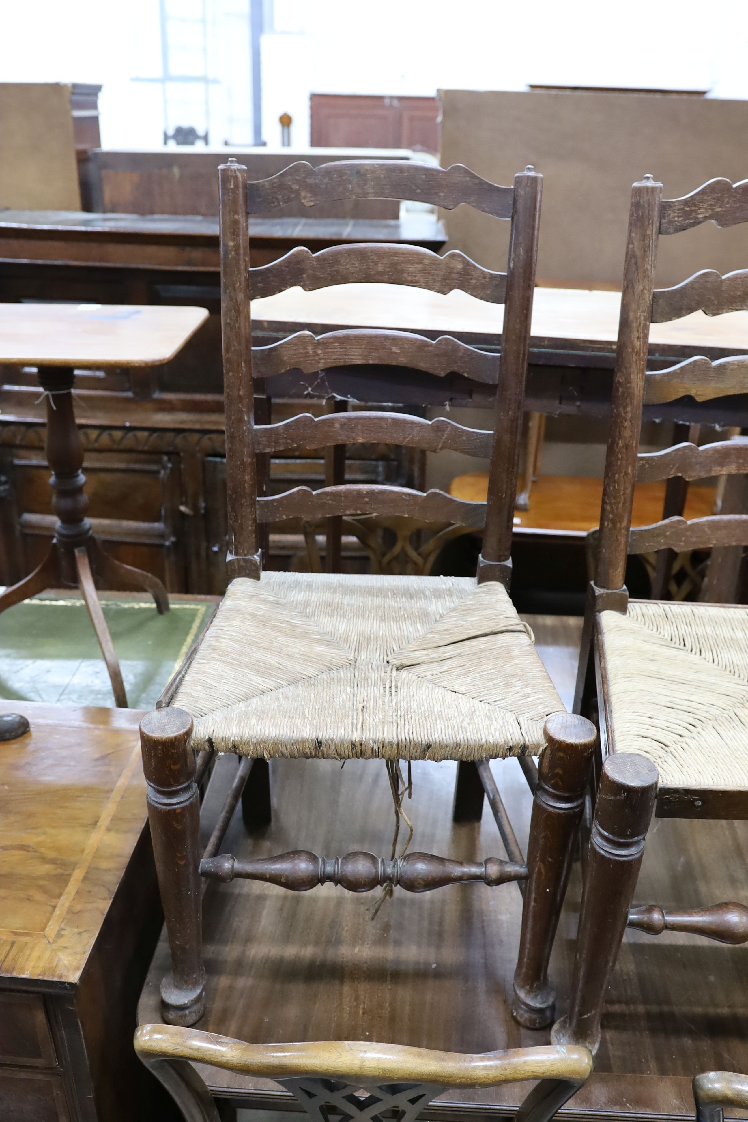 A set of six oak rush seat ladder back chairs